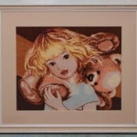 Little girl with a teddy bear - sewn and framed
