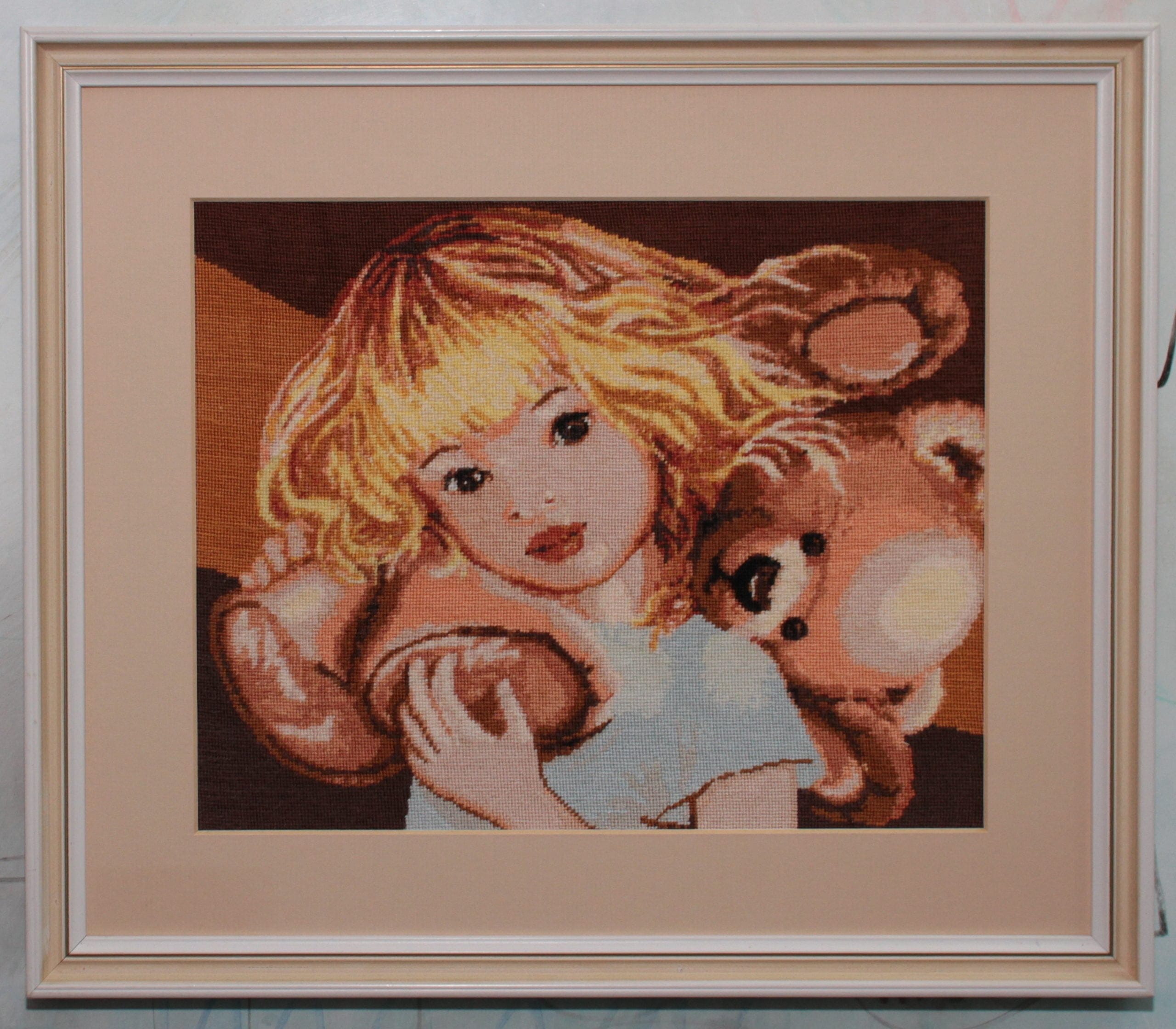 Little girl with a teddy bear - sewn and framed